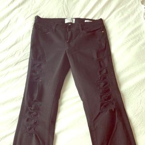Trendy black ripped designer jeans